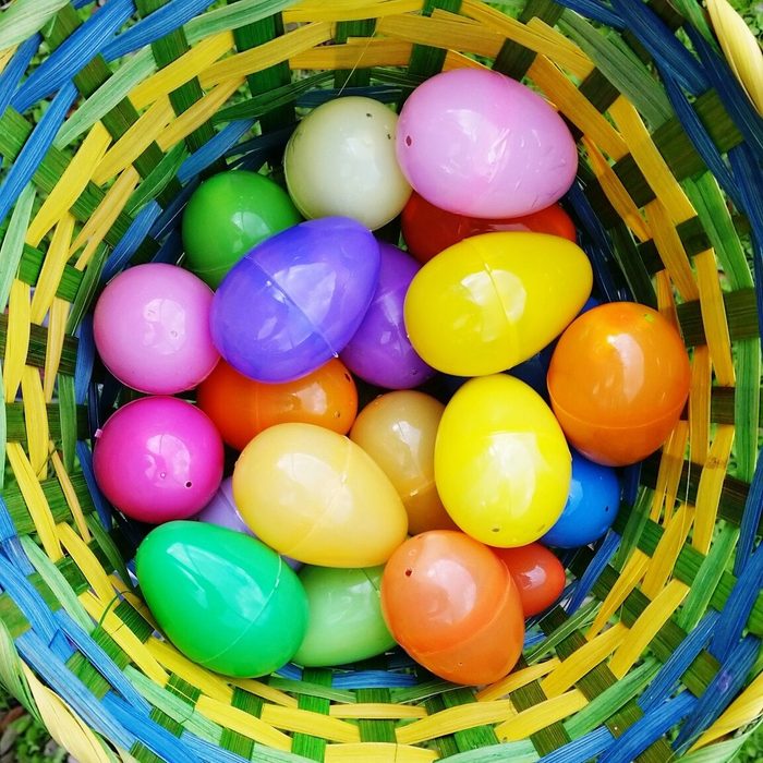 Directly Above Shot Of Easter Eggs In Basket On Grassy Field