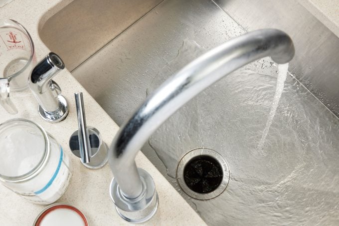 Cold Water Pouring Into Drain to flush out drain cleaner