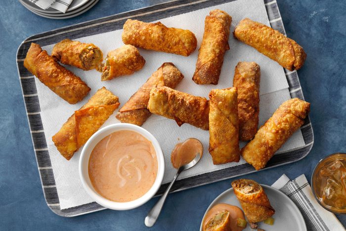 eggrolls on a tray with dipping sauce