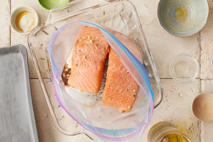 salmon in a clear plastic bag marinading