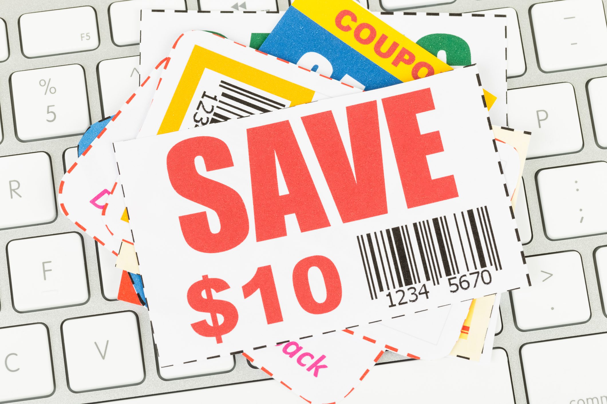 Saving discount coupon voucher on keyboard, coupons are mock-up