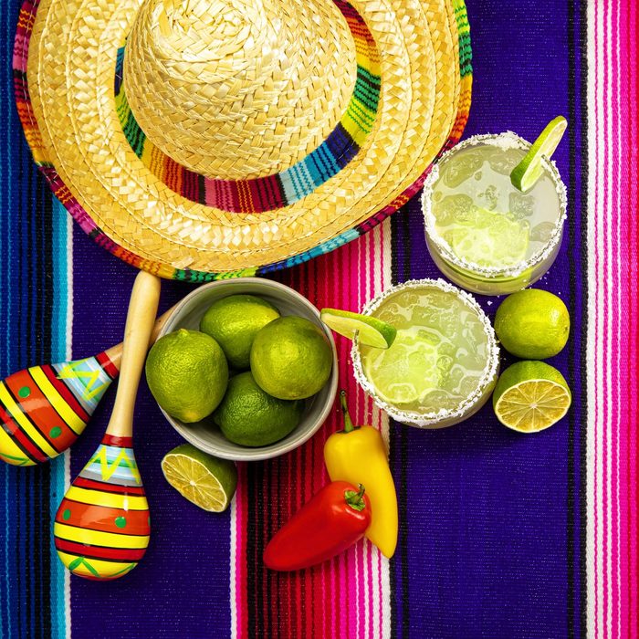 Happy Cinco de Mayo with two Margarita Glasses on a Colorful Mexican Blanket