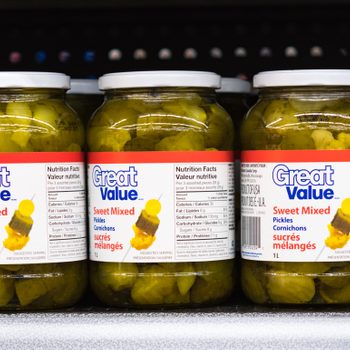 Great Value sweet mixed pickle jars on a store shelf. The...