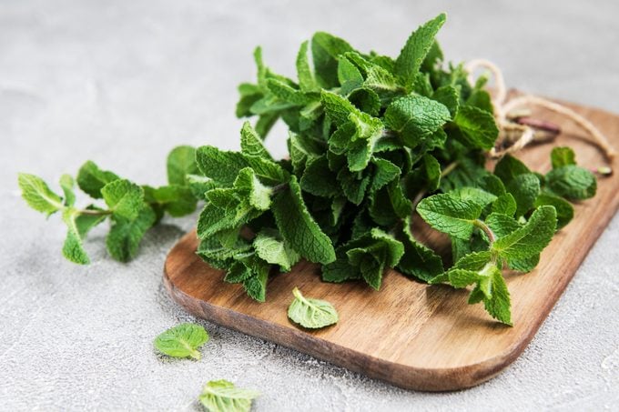 Fresh green mint on a old wooden board