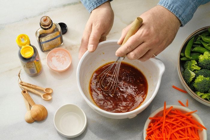 Vegan Stir Fry Shwoing Ingredients In A Bowl Being Stirred In.