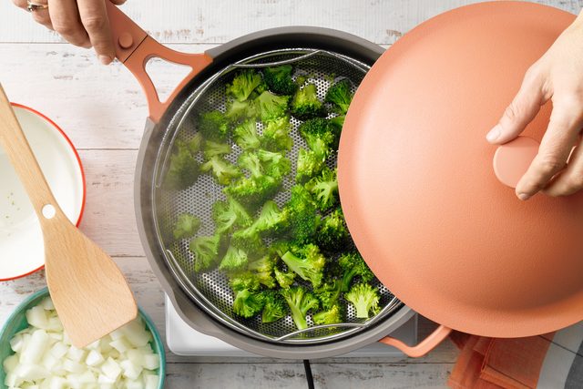 Steamed Broccoli In Steamer Basket for Vegan Broccoli Cheddar Soup