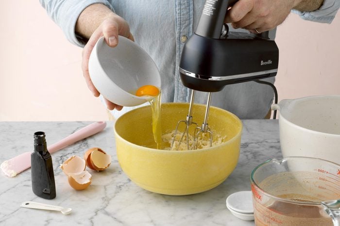 using an electric mixer to beat in eggs