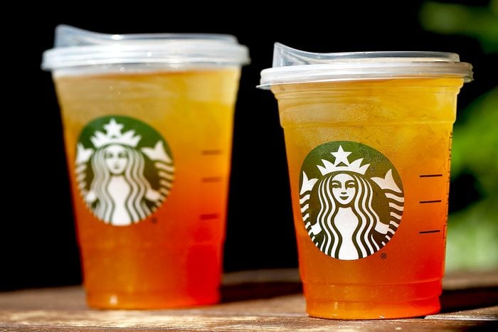 A new flat plastic lid that does not need a straw is shown on a cup of Starbucks iced tea