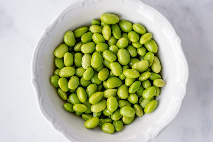 Overhead view of a bowl of shelled edamame beans