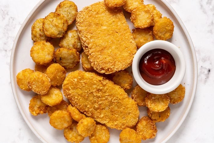 Hash browns on a plate with ketchup on a small plate