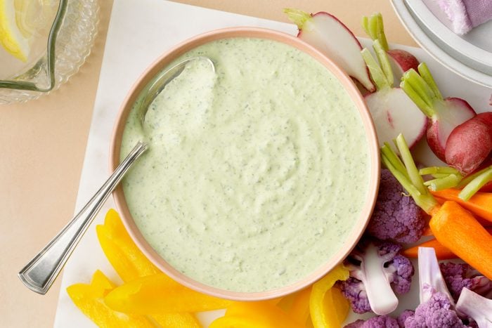 Green Goddess Dip in a bowl with a spoon