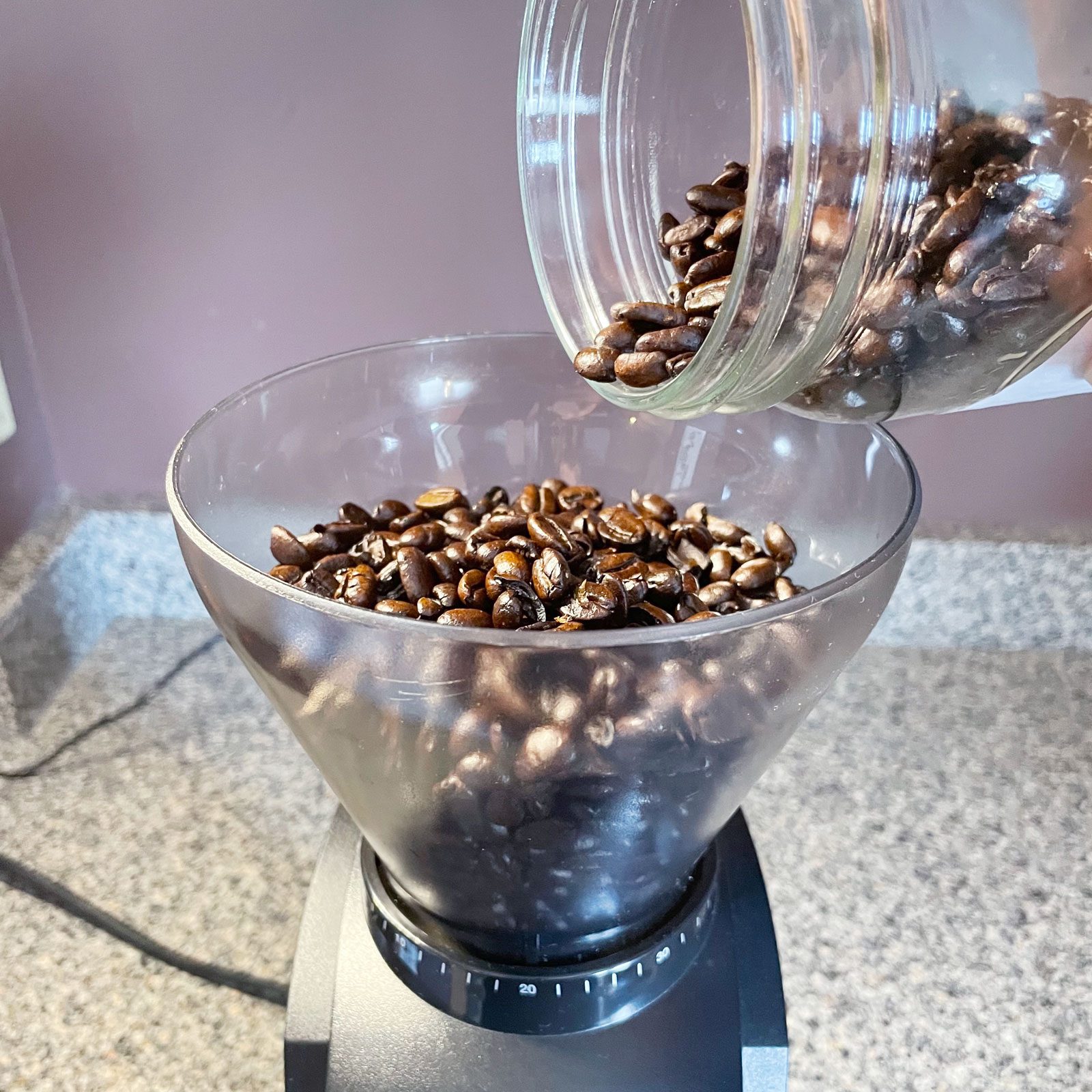 pouring coffee beans into the Baratza Encore Conical Burr Coffee Grinder