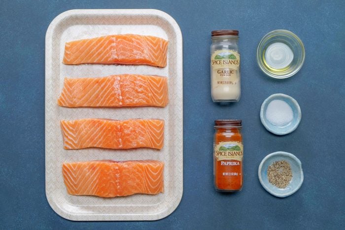 Olive oil, salmon and other seasoning on a table