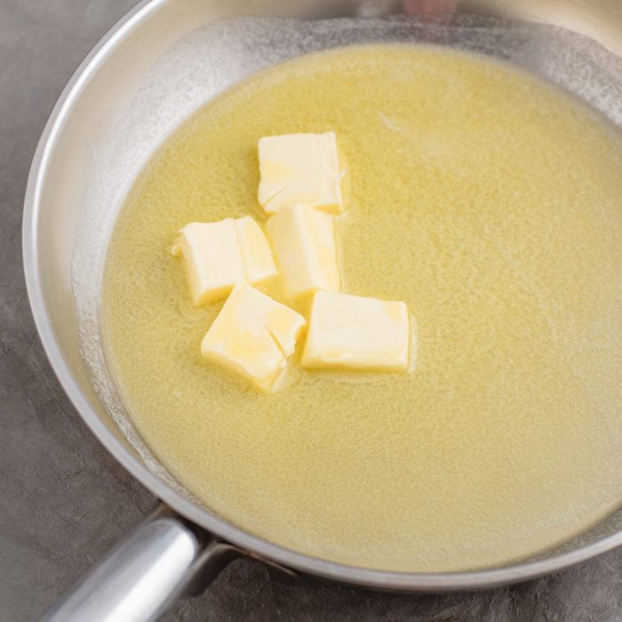 Chopped butter in silver skillet.