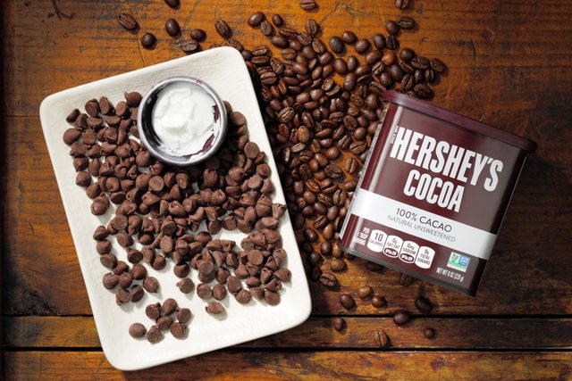 Hersheys Chocolate Chips On Plate With Cocoa and espresso beans On Wood Surface