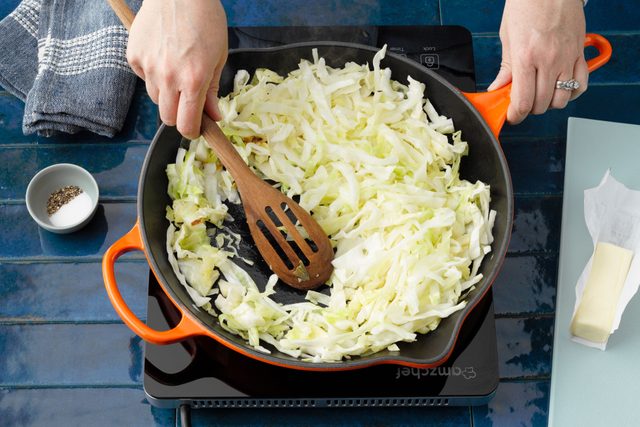 Cabbage Cooking And hands Stirring It
