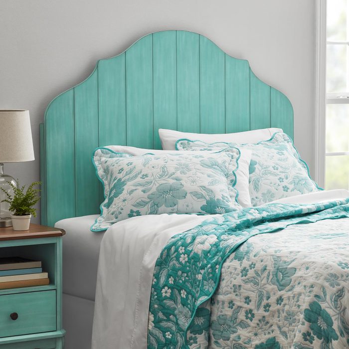 A Bed With a Blue Headboard
