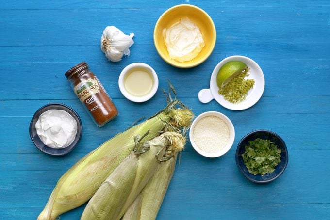 ingredients for Mexican street Corn on a blue wood background