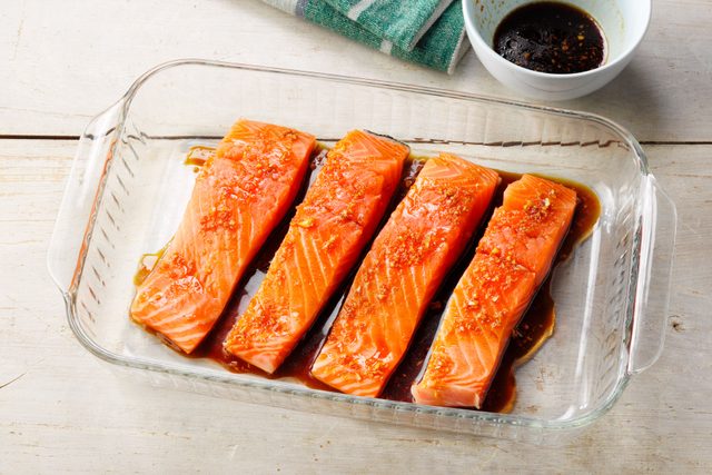 A Glass Dish With Salmon on It