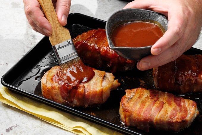 Pork Being Brushed With Barbecue Sauce