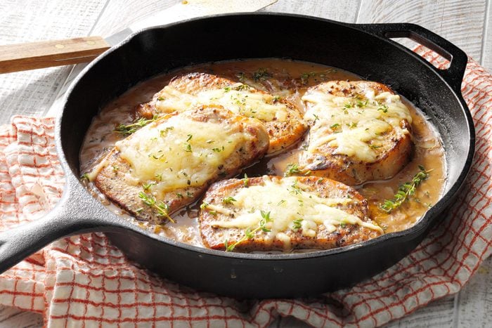 French Onion Pork Chops in a cast iron skillet