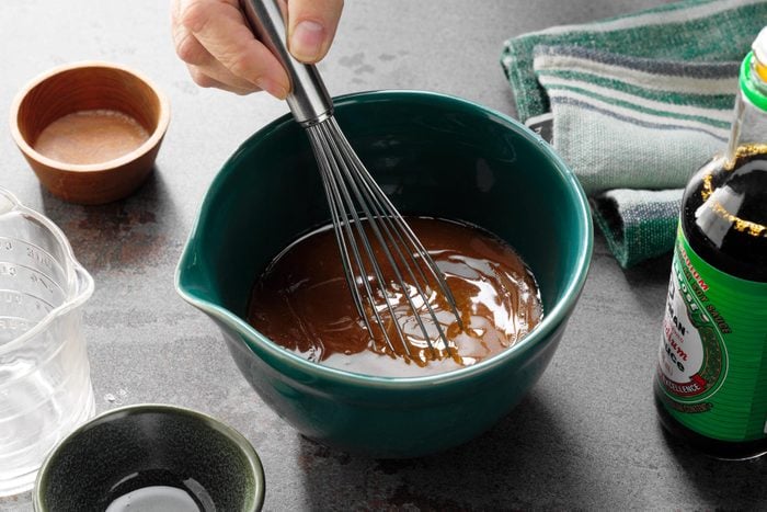 A Hand Whisking Ingredients in a Bowl