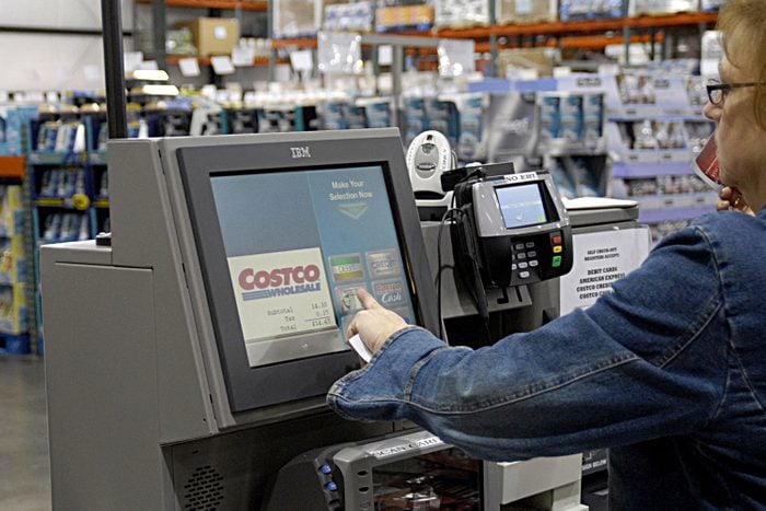 Shopper Uses Self Checkout at a Costco Wholesale Store to make grocery purchase