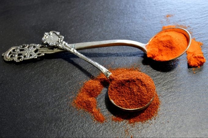 Paprika and chili powder in silver teaspoons