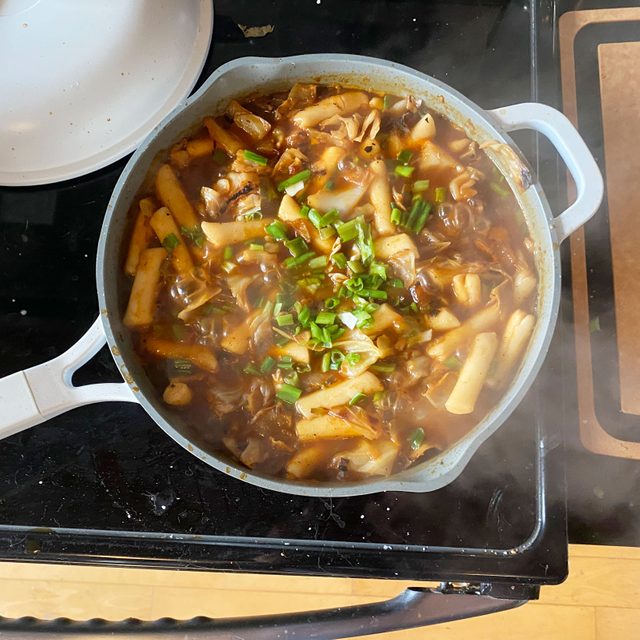 Hero Pan From Drew Barrymore on the stove with a one pot meal