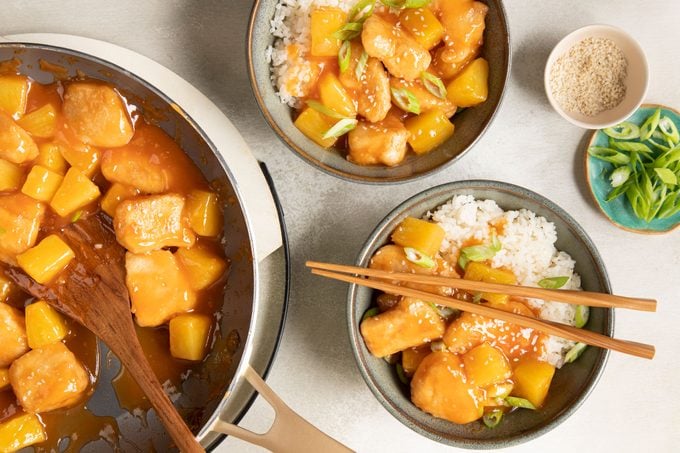 Sweet And Sour Chicken with rice bowl and chopsticks