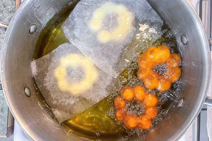mochi frying in a pot of oil