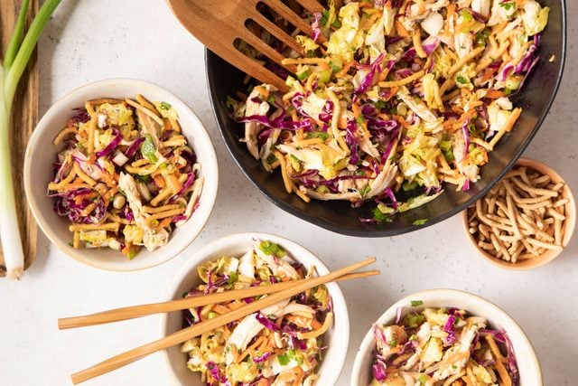 Chinese Chicken Salad in bowls with fork and chopsticks