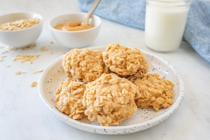 Peanut Butter No Bake Cookies on a white plate with a glass of milk