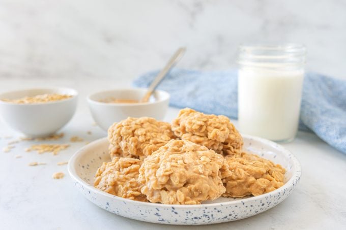 Peanut Butter No Bake Cookies on a white plate with a glass of milk