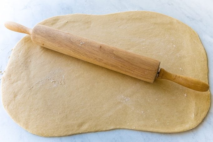 Flattening Dough with Rolling Pin for Blueberry Cinnamon Rolls Molly Allen For Toh 