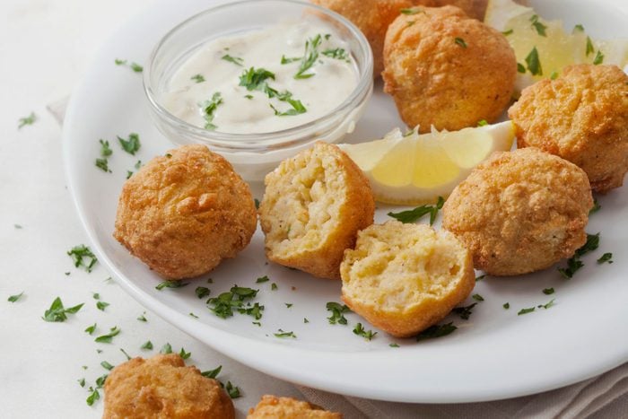 Southern Style Hush Puppies With A Creamy Dip Sauce and Chive Onions