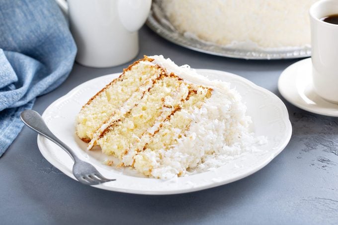 Coconut layer cake slice with coconut frosting