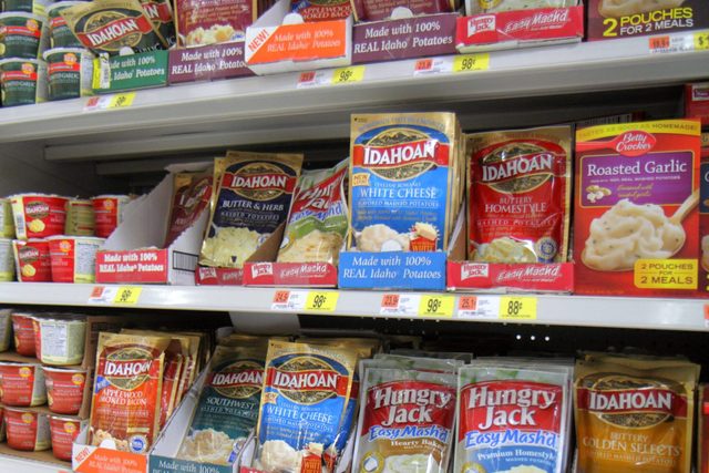 Shelves of instant mashed potatoes packets at a Walmart grocery store