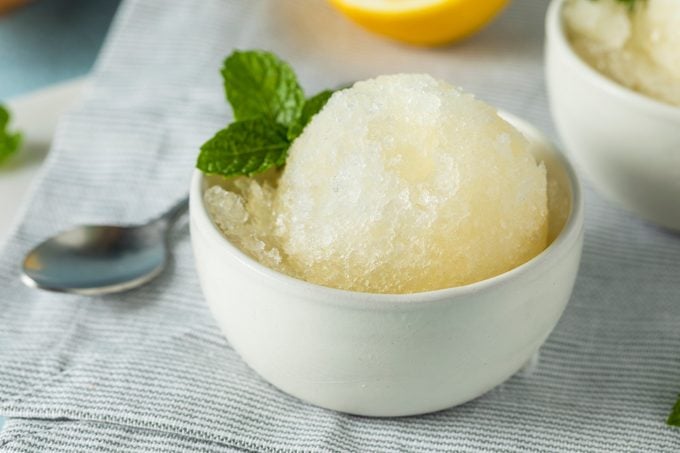 Homemade Yellow Lemon Italian Ice in a bowl resting on the counter