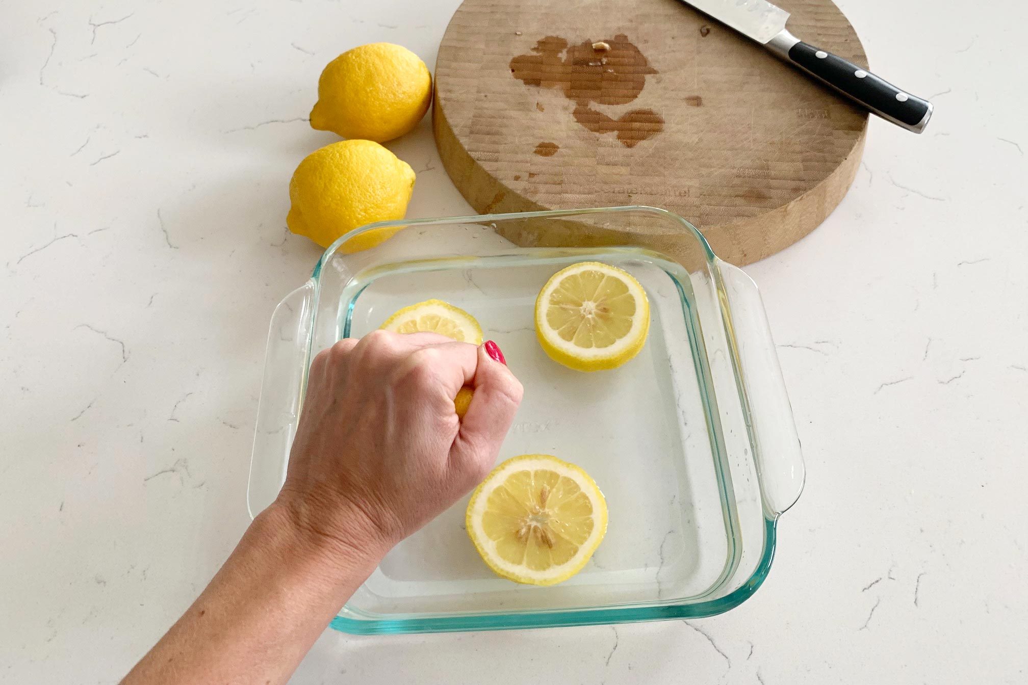 squeezing lemons into a dish