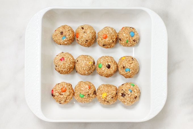 No Bake Monster Cookies Monsterballs in a white rectangular dish on marble counter