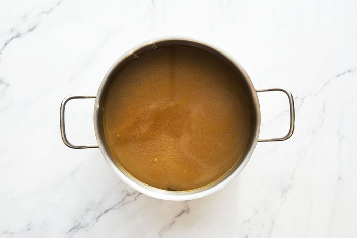 Chicken Stock Broth in a pot on a marble counter top