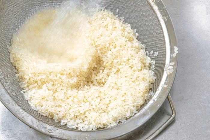 rinsing white rice in the sink