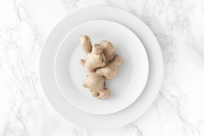 Ginger on white plate on marble background