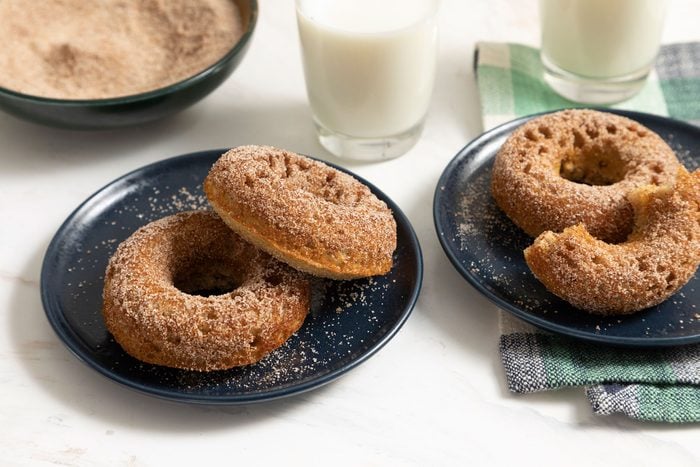 Cinnamon Sugar Doughnuts served on plates with milk ion the side
