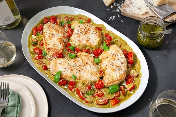 Cooked Creamy Pesto Chicken on serving dish on dining table