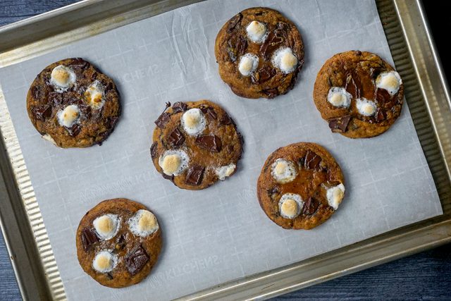Baked pumpkin smore cookies on parchment paper