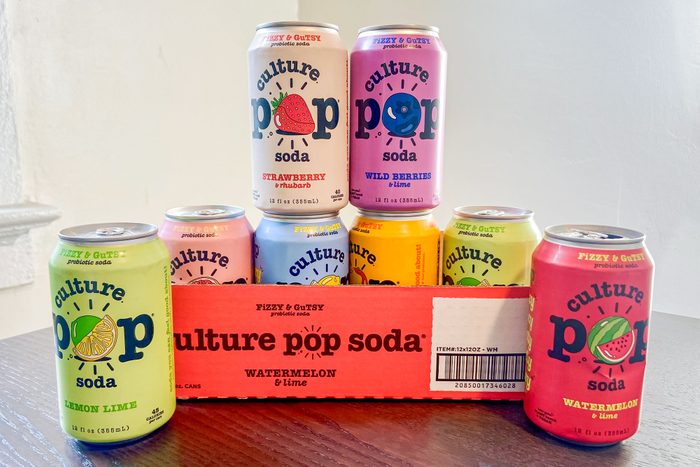 Culture Pop Soda Cans on Wooden Surface