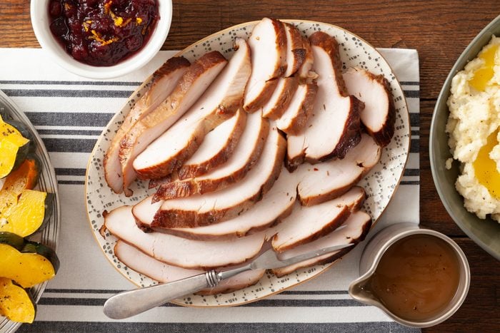 Brined Grilled Turkey Breast sliced on a serving plate