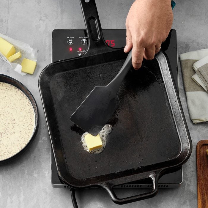 Heating griddle with butter and spatula